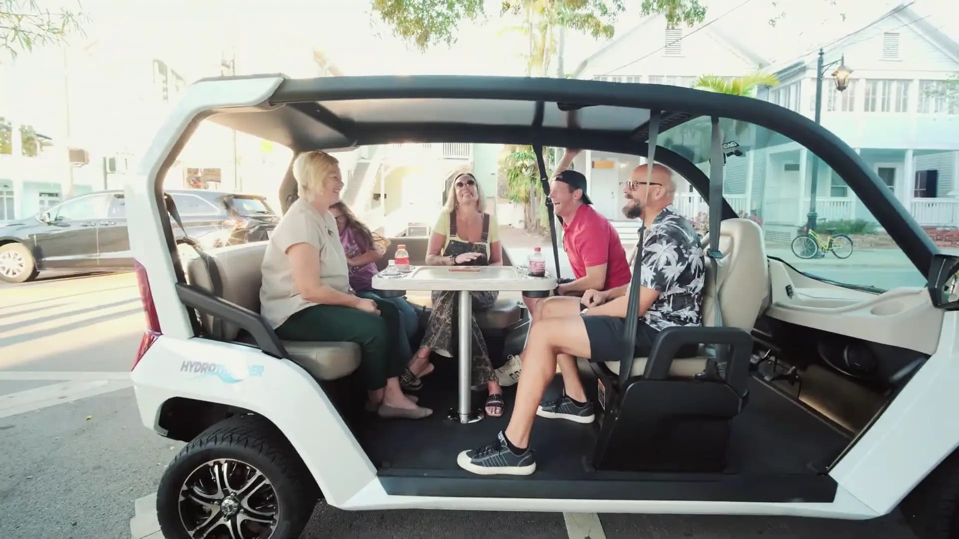 Group of friends hanging out in an electric car with table
