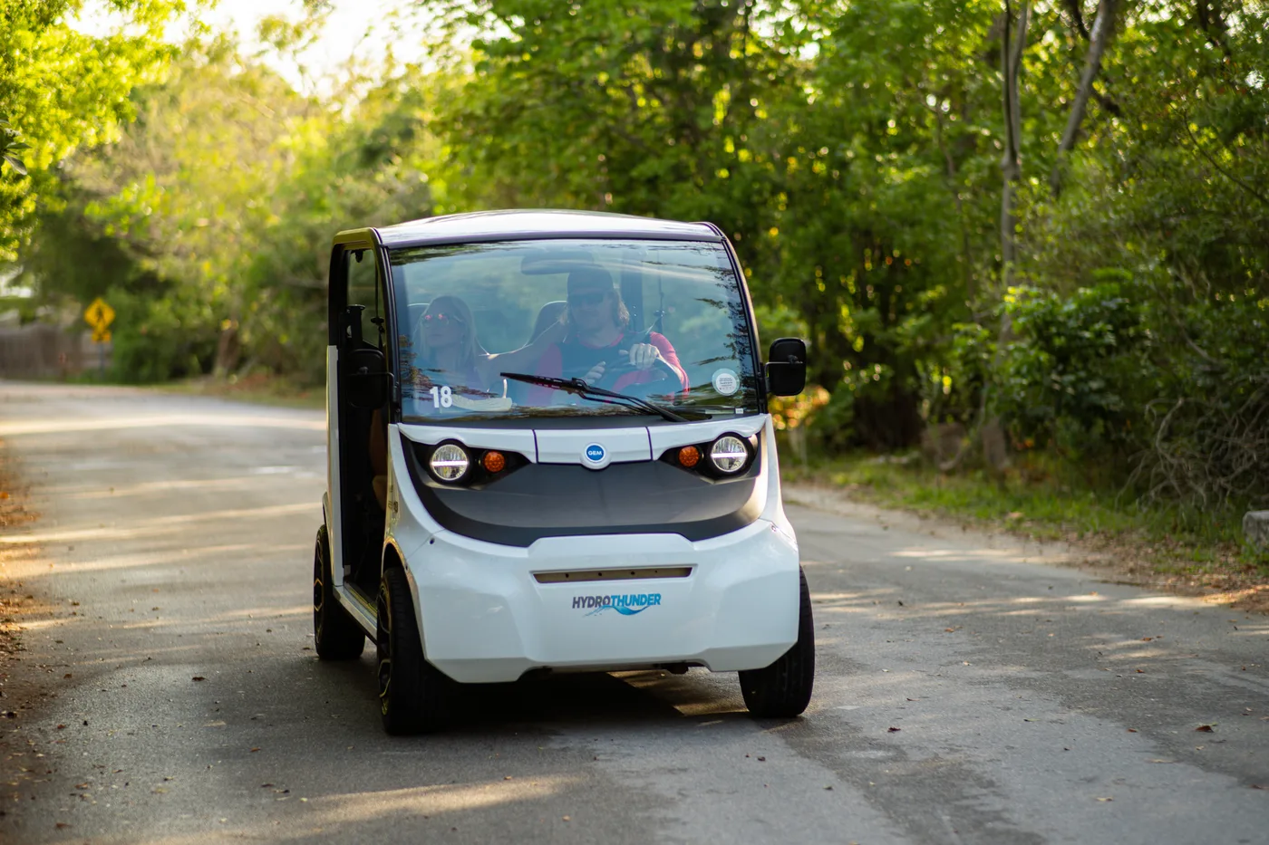 HydroThunder electric car cruising a quiet tree-lined road