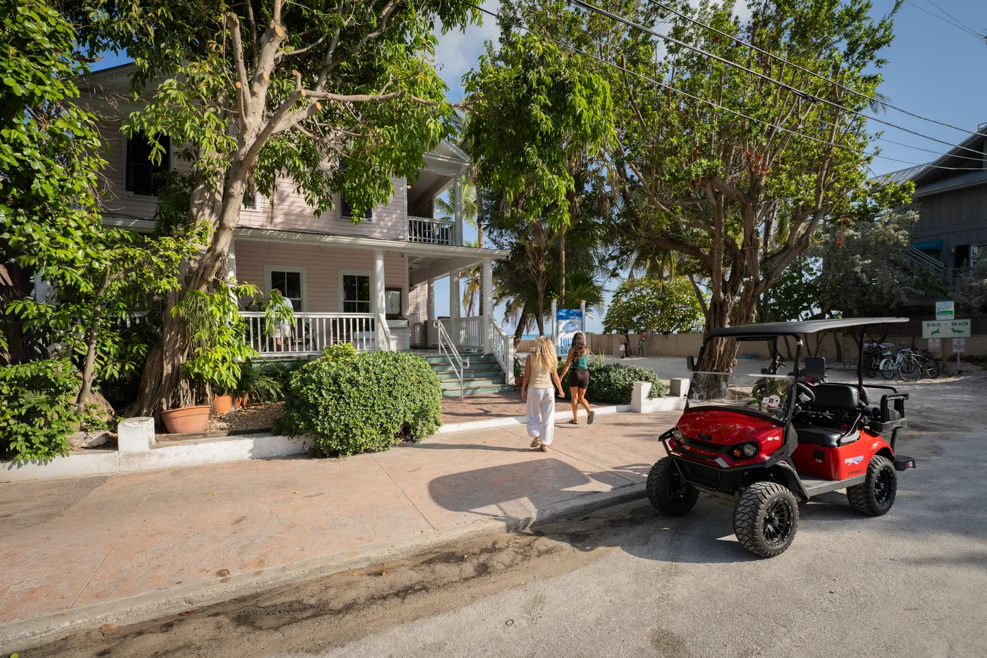 Red golf cart parked outside a Key West rental location