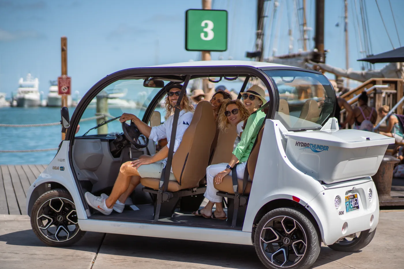 Group in electric car at the marina