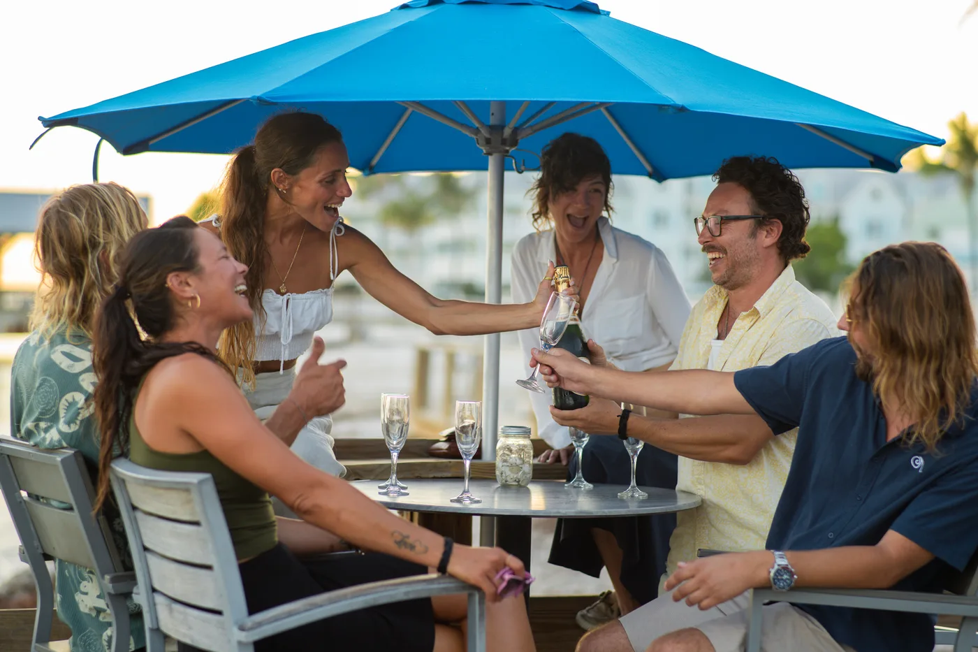 Friends celebrating with champagne outdoors
